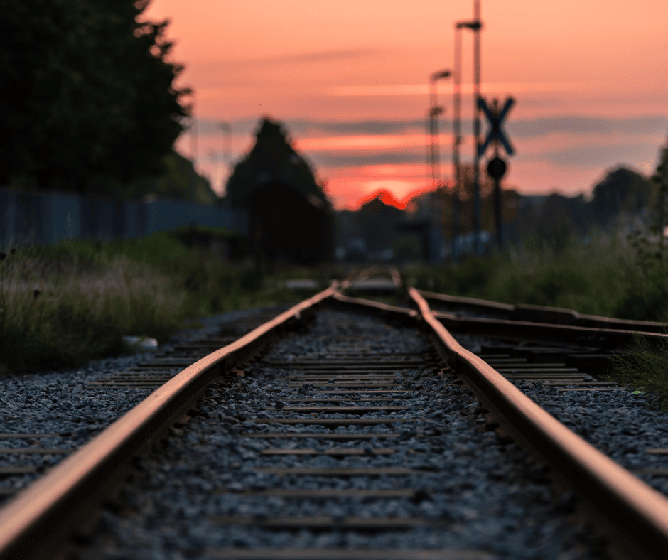 A picture of railroad tracks at sunset.