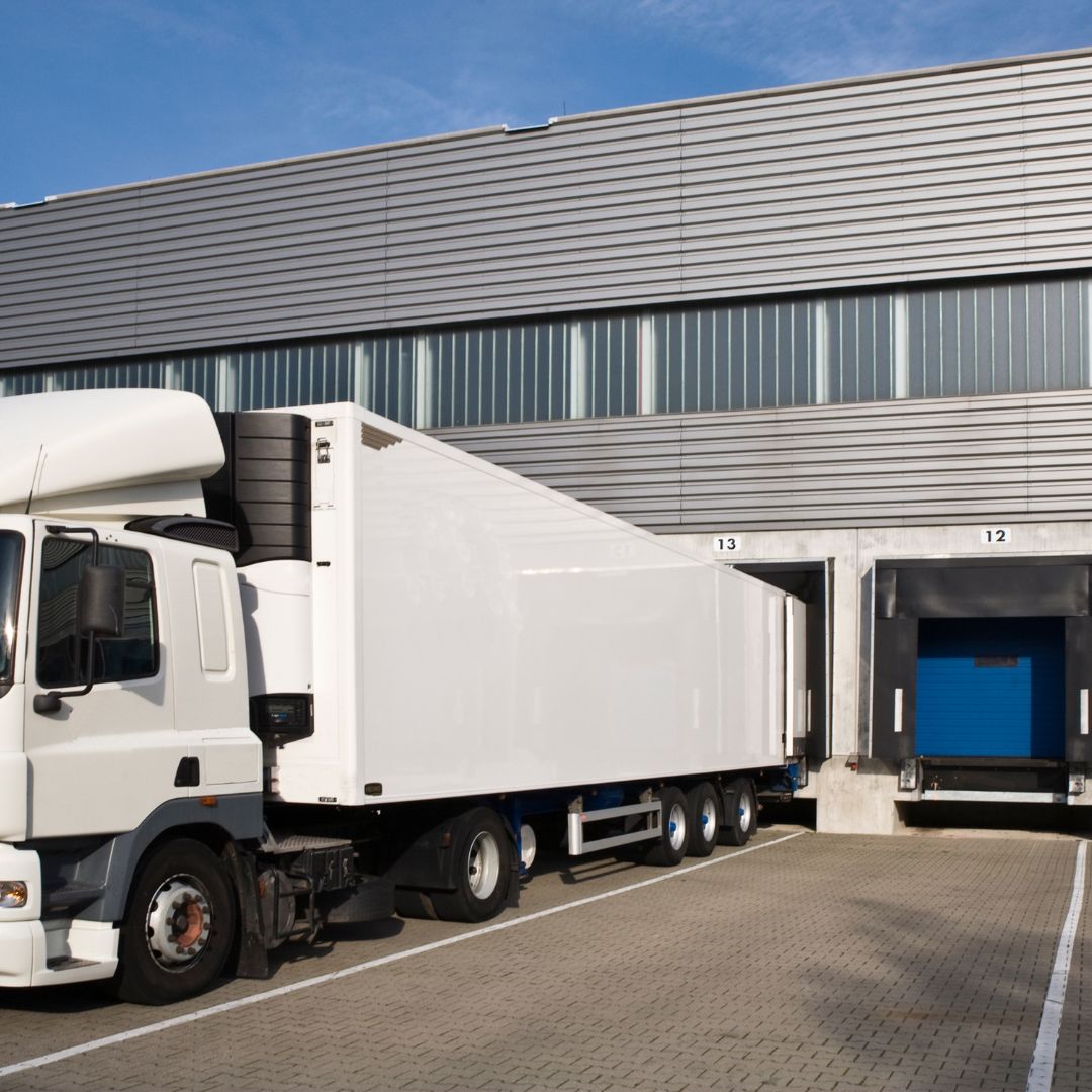 An example of transportation services. An image of a truck docked at a warehouse.