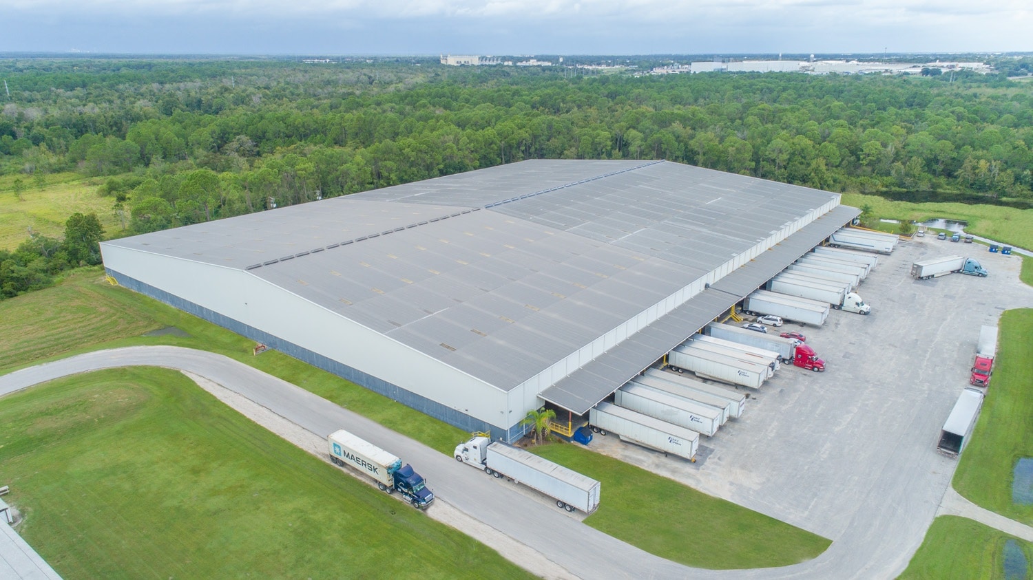warehouse with trucks drone footage