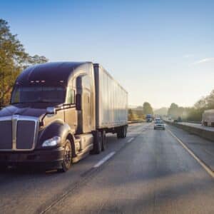 A semi-truck going down the highway.