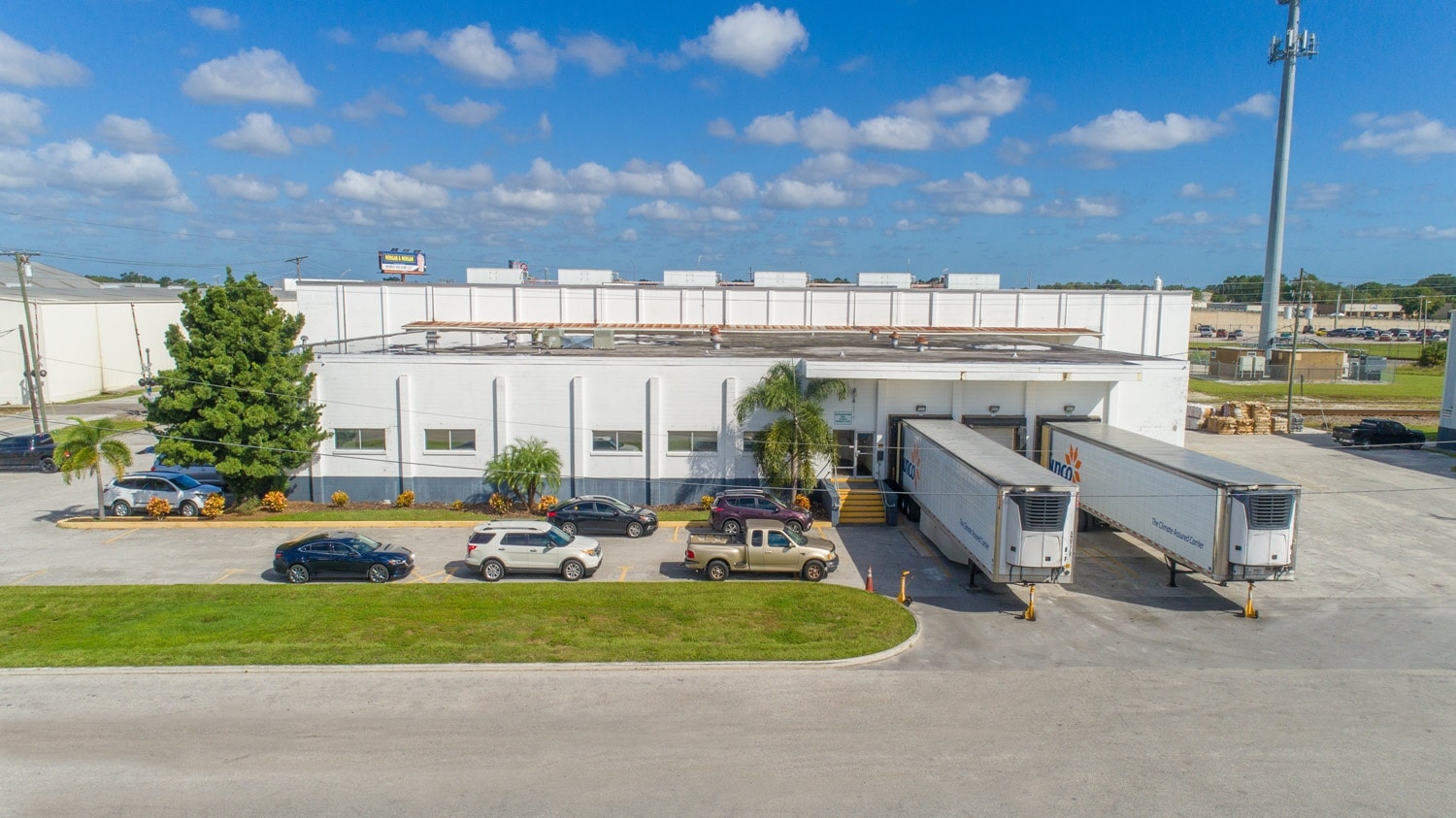 An image of the CWI T2 warehouse with trucks at a loading dock.