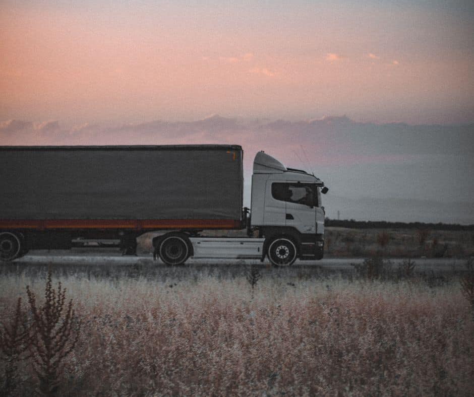 An image of a semi-truck driving down the road providing 3PL services to customers.